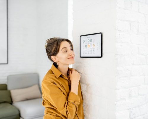 woman-controlling-home-with-a-digital-touch-screen